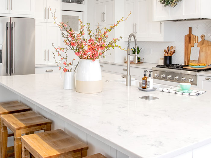 marble kitchen island countertop with a vase full of flowers on